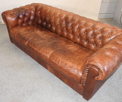 Lot 352 - A modern brown leather upholstered button back chesterfield sofa