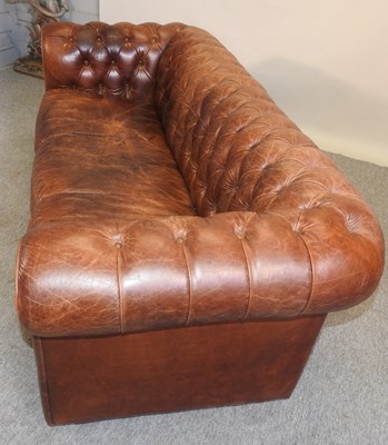 Lot 352 - A modern brown leather upholstered button back chesterfield sofa