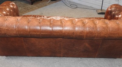 Lot 352 - A modern brown leather upholstered button back chesterfield sofa