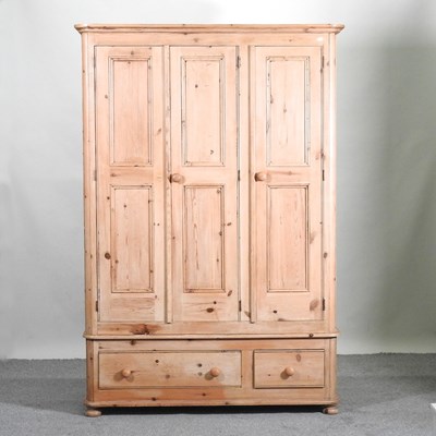 Lot 583 - A pine triple wardrobe