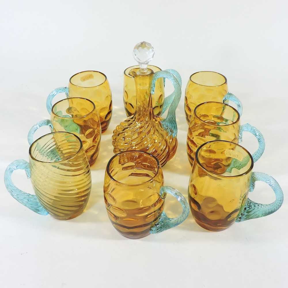 Lot 282 - An amber glass decanter set