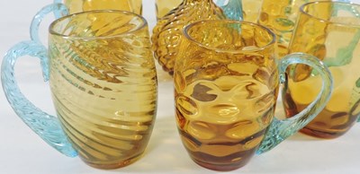 Lot 282 - An amber glass decanter set