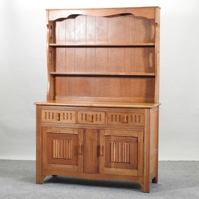 Lot 689 - An Ercol style elm dresser