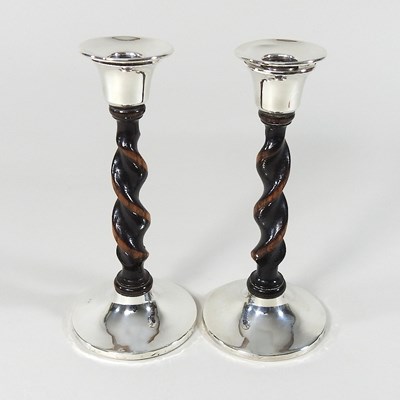 Lot 182 - A pair of silver mounted candlesticks