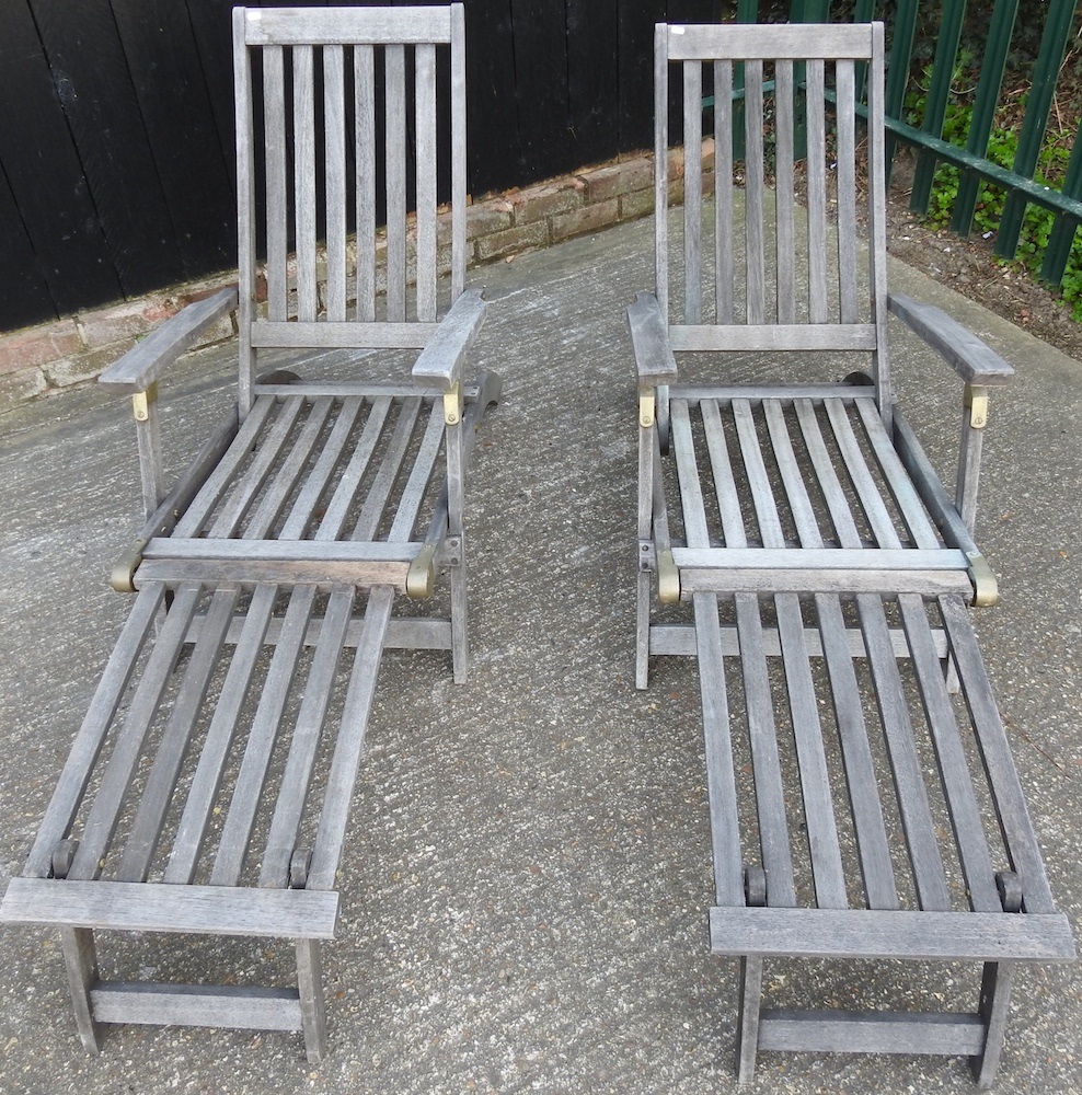 Lot 464 A pair of teak steamer chairs