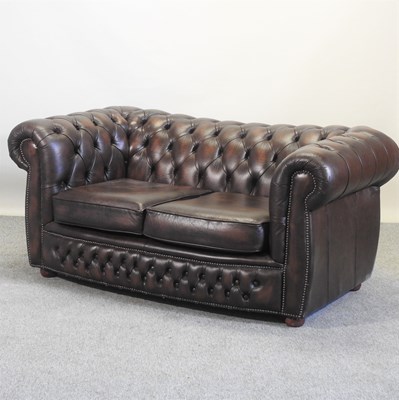 Lot 306 - A brown leather upholstered chesterfield sofa