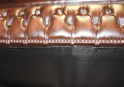 Lot 306 - A brown leather upholstered chesterfield sofa