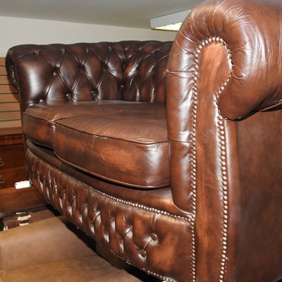 Lot 306 - A brown leather upholstered chesterfield sofa