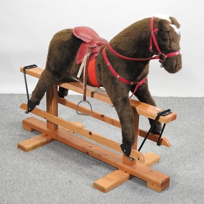 Lot 387 - A mid 20th century upholstered rocking horse