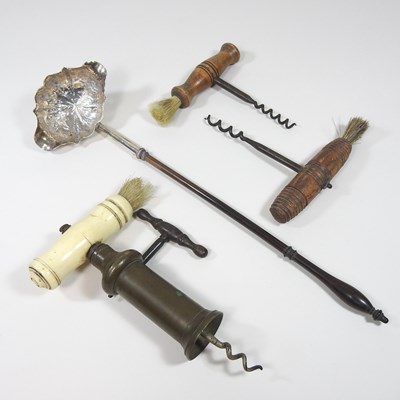 Lot 274 - A collection of corkscrews and a toddy ladle