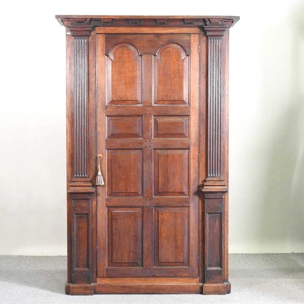 Lot 402 - An oak hall cupboard